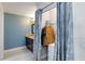 Walk-in closet with custom curtains and shelving that leads to a granite vanity in the bathroom at 9338 Palm Tree Dr, Windermere, FL 34786
