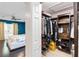 Large walk-in closet with custom shelving and storage and a partial view of the main bedroom at 9338 Palm Tree Dr, Windermere, FL 34786