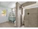 Bathroom with a shower and an exterior door leading to backyard at 1004 Moccasin Run Rd, Oviedo, FL 32765
