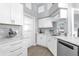 Modern kitchen with stainless steel appliances, marble countertops, and white cabinetry at 1004 Moccasin Run Rd, Oviedo, FL 32765