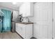 Bright laundry room featuring white cabinets, subway tile backsplash, washer, and dryer at 1004 Moccasin Run Rd, Oviedo, FL 32765