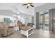 Cozy living room with hardwood floors, comfortable seating, and a sliding door to the pool at 1004 Moccasin Run Rd, Oviedo, FL 32765
