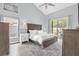 Bright main bedroom featuring a king bed, a ceiling fan, and ensuite bathroom access at 1004 Moccasin Run Rd, Oviedo, FL 32765