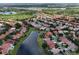 An aerial view of a neighborhood with a lake and the subject home highlighted with a marker at 1027 Algare Loop, Windermere, FL 34786