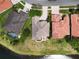 An aerial view showing property boundaries next to a lake with neighboring properties and manicured lawns at 1027 Algare Loop, Windermere, FL 34786