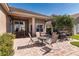 Brick paved lanai features an outdoor table and chairs, along with a view of a well-maintained yard and lake at 1027 Algare Loop, Windermere, FL 34786