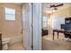 Bathroom with a tub and shower combo, a toilet, and doorway to the office at 1027 Algare Loop, Windermere, FL 34786