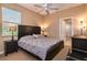 Bedroom with gray bedding, beige walls, and a ceiling fan provides lots of natural light at 1027 Algare Loop, Windermere, FL 34786