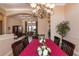 Elegant dining room featuring a chandelier over a dining table and an archway to the living room at 1027 Algare Loop, Windermere, FL 34786