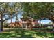 Charming home with a black iron fence, mature trees, and well-maintained landscaping at 1027 Algare Loop, Windermere, FL 34786