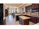 Open kitchen with dark cabinetry, island, tile backsplash, and stainless steel appliances at 1027 Algare Loop, Windermere, FL 34786