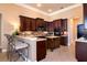 Spacious kitchen featuring an island, breakfast bar, and dark wood cabinetry at 1027 Algare Loop, Windermere, FL 34786