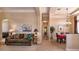 Comfortable living room featuring tile floors, a sofa, and an archway to the dining room at 1027 Algare Loop, Windermere, FL 34786