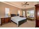 Cozy main bedroom with tray ceiling, large windows, and elegant furnishings at 1027 Algare Loop, Windermere, FL 34786