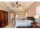 Spacious main bedroom features tray ceilings, a ceiling fan, and access to the main bath at 1027 Algare Loop, Windermere, FL 34786