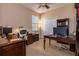 Office with a ceiling fan, desk, shelving, and a window providing natural light at 1027 Algare Loop, Windermere, FL 34786