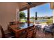 Covered patio with brick pavers, a ceiling fan, dining furniture, lounge chairs, and tranquil lake view at 1027 Algare Loop, Windermere, FL 34786