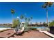 Colorful community playground with slides, climbing structures, and palm trees, near the lake and pool at 1027 Algare Loop, Windermere, FL 34786