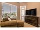 Bedroom sitting area with comfortable chair and view of the lake at 1027 Algare Loop, Windermere, FL 34786