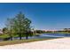 Lakeside sand volleyball court with net in place, set against a clear blue sky at 1027 Algare Loop, Windermere, FL 34786