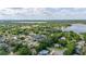 Elevated view of neighborhood featuring lake views, lush greenery and scattered residences at 1034 Featherstone Cir, Ocoee, FL 34761