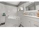 Chic bathroom featuring marble backsplash, garden tub, and neutral decor at 1034 Featherstone Cir, Ocoee, FL 34761