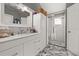 Bright bathroom with walk-in shower, storage cabinets and marble countertops at 1034 Featherstone Cir, Ocoee, FL 34761