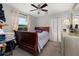 Cozy bedroom featuring a wood sleigh bed, neutral walls, and a ceiling fan at 1034 Featherstone Cir, Ocoee, FL 34761