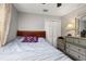 Comfortable bedroom features a ceiling fan, closet, and natural light from the window at 1034 Featherstone Cir, Ocoee, FL 34761