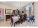 Bright dining room featuring a hardwood dining table, cabinet and chandelier lighting at 1034 Featherstone Cir, Ocoee, FL 34761