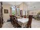 Elegant dining room with hardwood table set and beautiful chandelier lighting features at 1034 Featherstone Cir, Ocoee, FL 34761