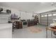 Spacious garage with kitchen setup featuring brown cabinets and stainless steel appliances at 1034 Featherstone Cir, Ocoee, FL 34761