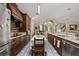 Spacious kitchen with stainless steel appliances and dark wood cabinetry and dining table at 1034 Featherstone Cir, Ocoee, FL 34761