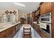Spacious kitchen with stainless steel appliances and dark wood cabinetry at 1034 Featherstone Cir, Ocoee, FL 34761