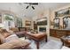Inviting living room with stone fireplace, comfortable seating and natural light at 1034 Featherstone Cir, Ocoee, FL 34761