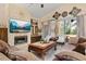 Cozy living room featuring a stone fireplace, large windows and comfortable seating at 1034 Featherstone Cir, Ocoee, FL 34761