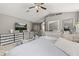 Comfortable main bedroom featuring a TV, lots of drawers and decor at 1034 Featherstone Cir, Ocoee, FL 34761