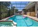 Heated, enclosed pool with a spa, clear blue water and surrounding lush landscaping for ultimate backyard enjoyment at 1034 Featherstone Cir, Ocoee, FL 34761