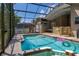 Inviting enclosed swimming pool with integrated hot tub and adjacent seating area at 1034 Featherstone Cir, Ocoee, FL 34761