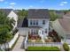 Elevated rear view of light blue two-story home with white picket fence and manicured landscaping at 109 Grinnell Pl, Celebration, FL 34747