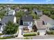An aerial shot highlights the home's location within a lush neighborhood with tree-lined streets at 109 Grinnell Pl, Celebration, FL 34747