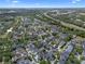 Breathtaking aerial perspective of a sprawling community, featuring diverse architecture, lush landscaping, and scenic views at 109 Grinnell Pl, Celebration, FL 34747