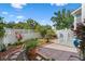 A fenced backyard with brick patio, lush greenery, and well-maintained landscaping at 109 Grinnell Pl, Celebration, FL 34747