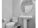 Elegant half bath with pedestal sink, modern fixtures, and neutral wall color at 109 Grinnell Pl, Celebration, FL 34747