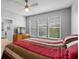 Bedroom featuring bright windows, ceiling fan, and ensuite bathroom at 109 Grinnell Pl, Celebration, FL 34747