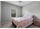 Bright bedroom featuring a colorful bedspread and natural light from a window at 109 Grinnell Pl, Celebration, FL 34747