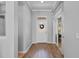 Bright foyer with hardwood floors, white door and wreath, and access to adjacent rooms at 109 Grinnell Pl, Celebration, FL 34747