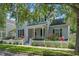 Inviting two-story home with a bright red door, white picket fence, and colorful flowers enhancing curb appeal at 109 Grinnell Pl, Celebration, FL 34747