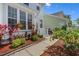 Charming front yard with colorful landscaping and a welcoming walkway to the front door at 109 Grinnell Pl, Celebration, FL 34747