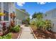 The inviting walkway leads to the home, surrounded by colorful plants and fresh landscaping at 109 Grinnell Pl, Celebration, FL 34747